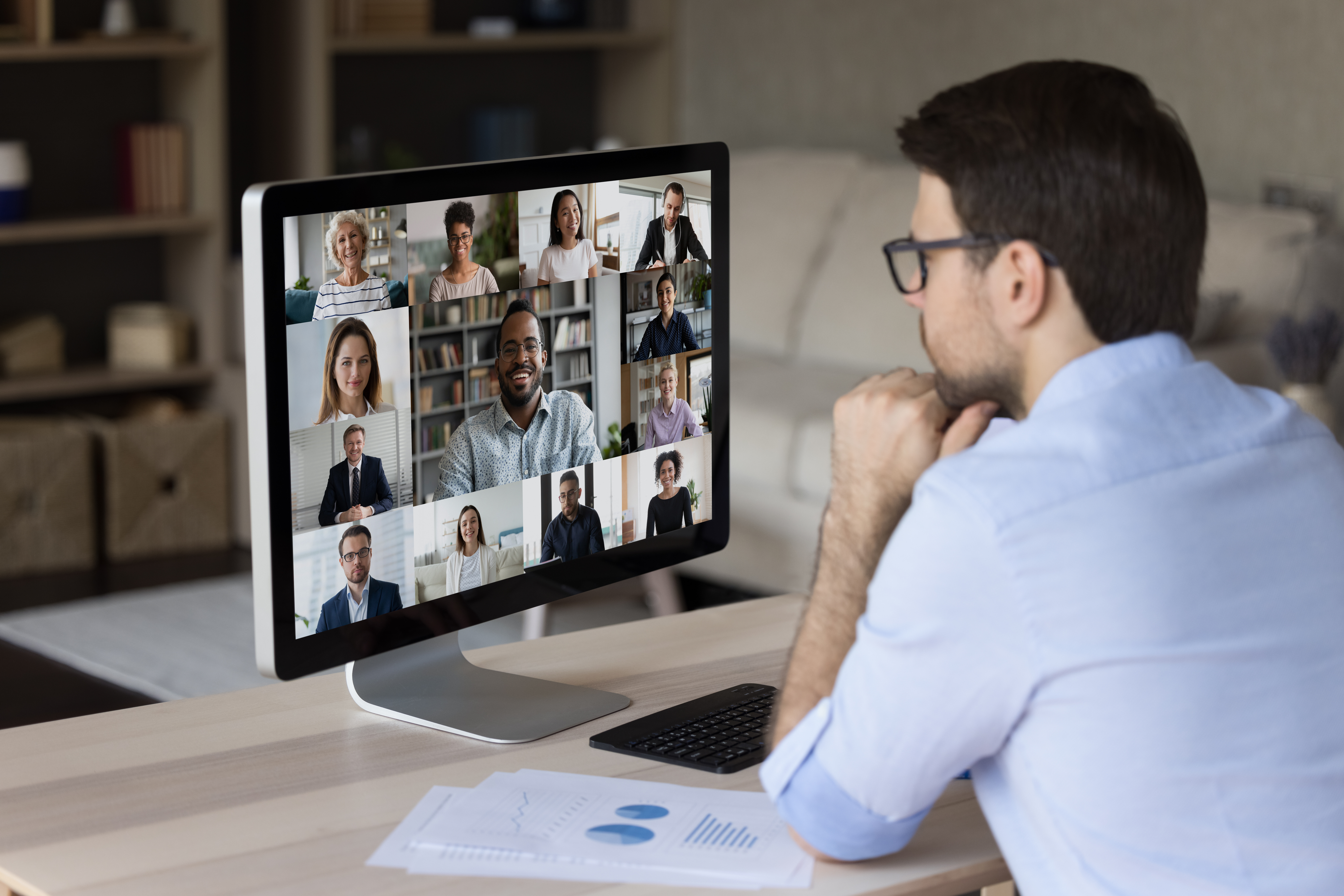 Focused young businessman holding video conference call.