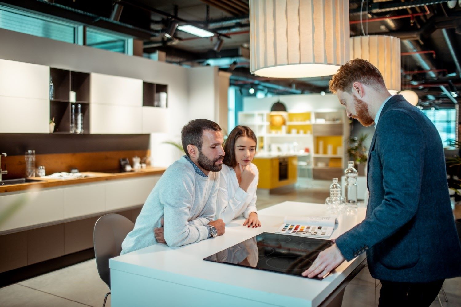 Couple receiving help from an employee in a retail showroom