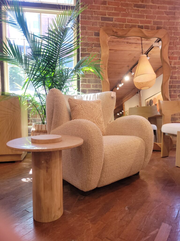 Side table, chair and mirror in a furniture showroom