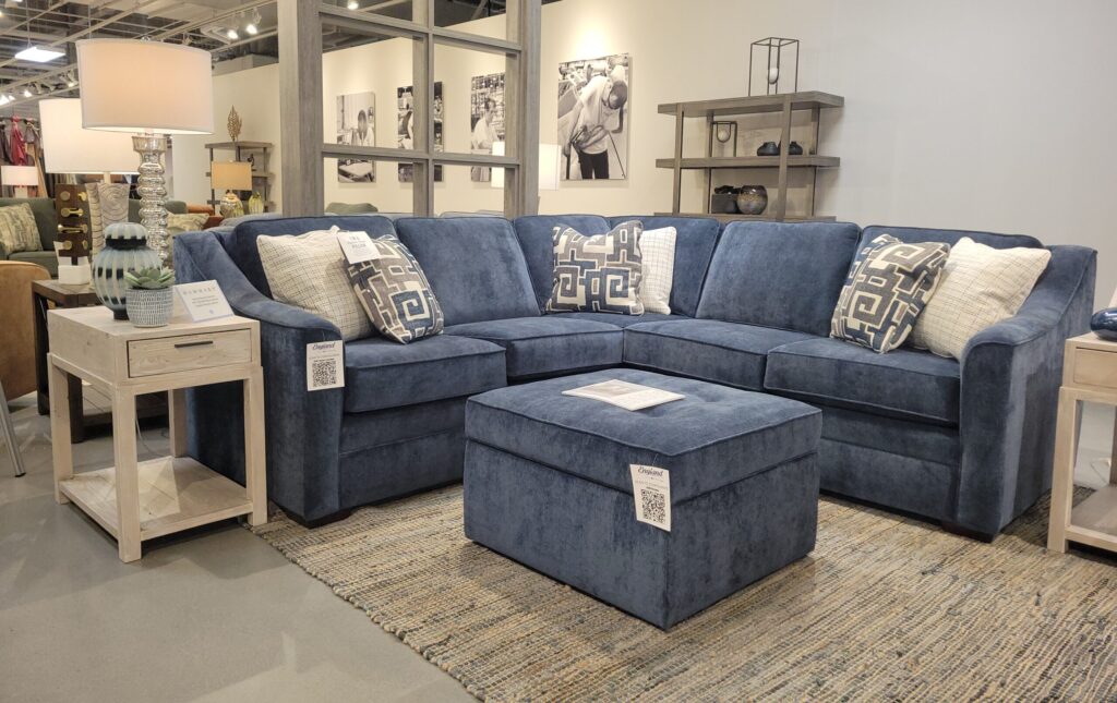 Blue sectional sofa and footrest in a showroom