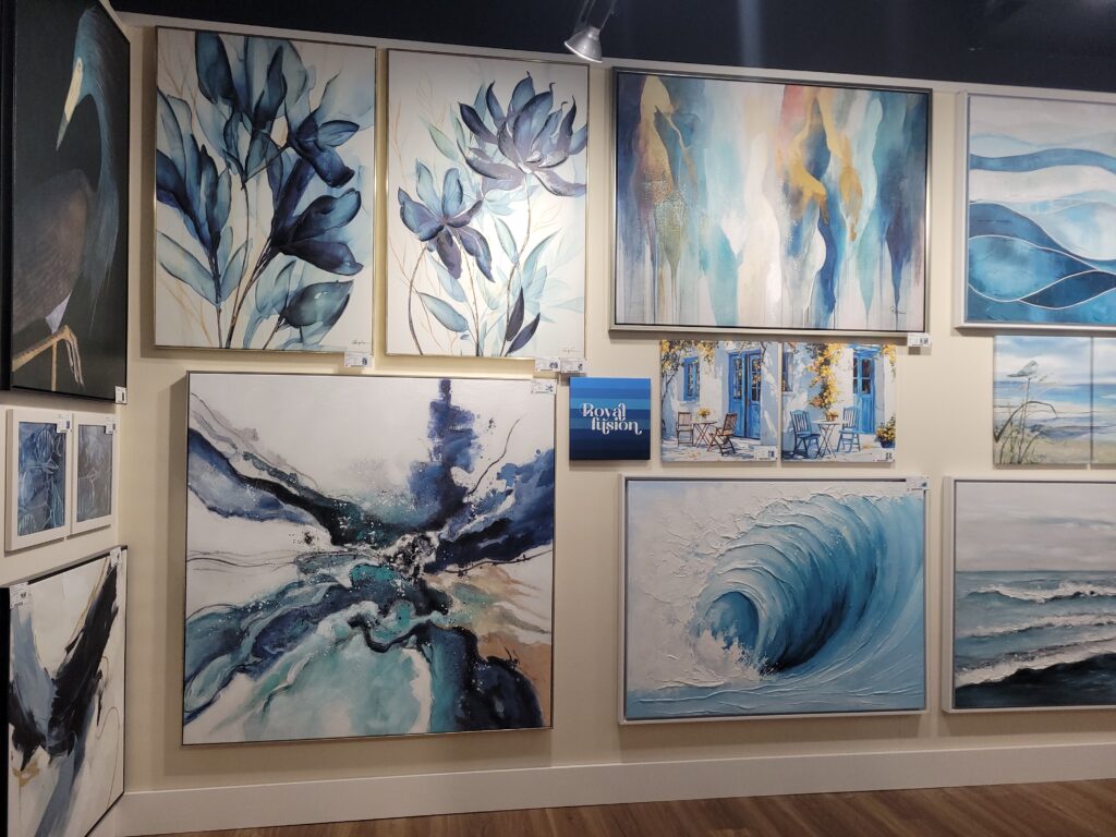Wall of blue toned paintings in a showroom
