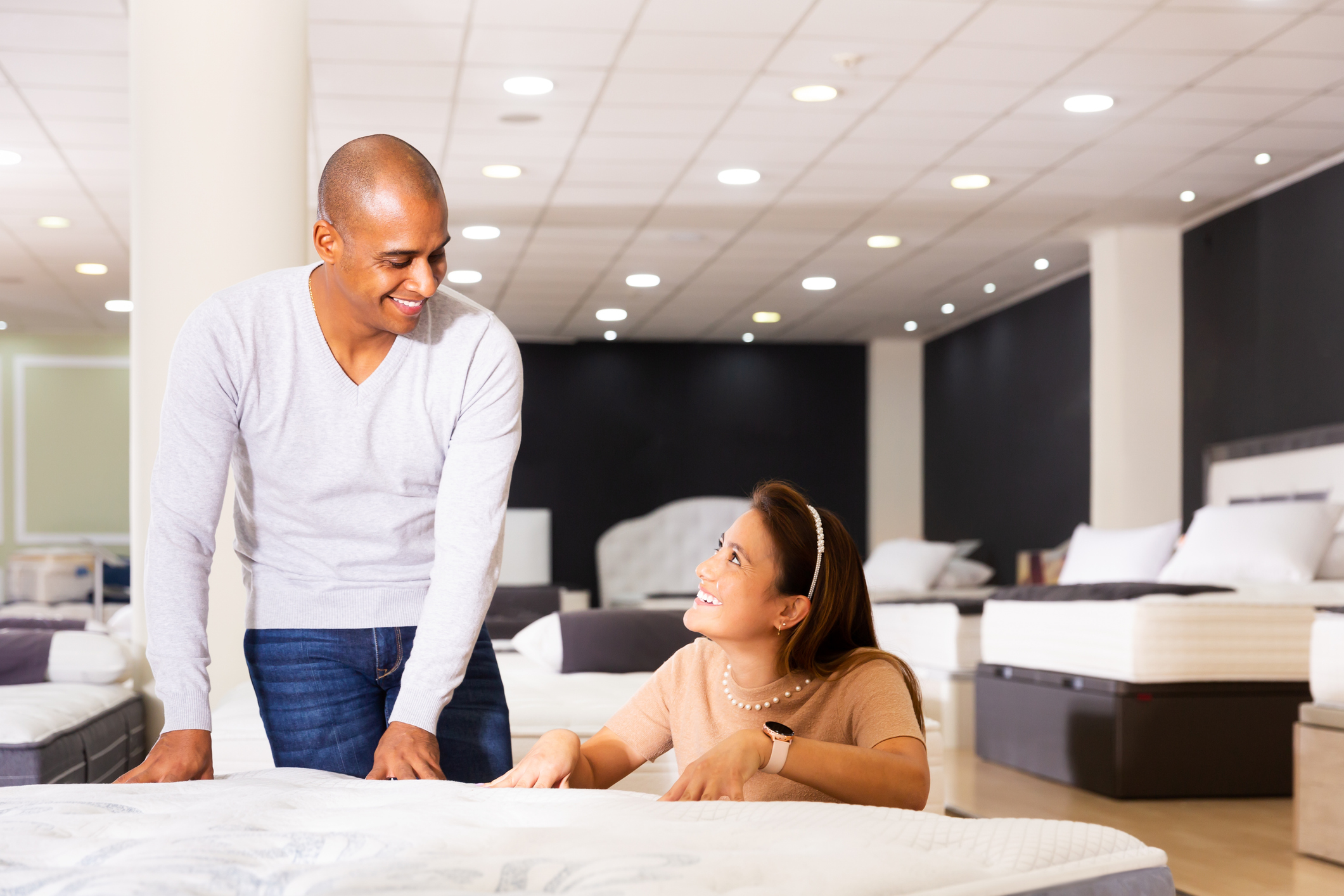 Man and woman shopping in a mattress store