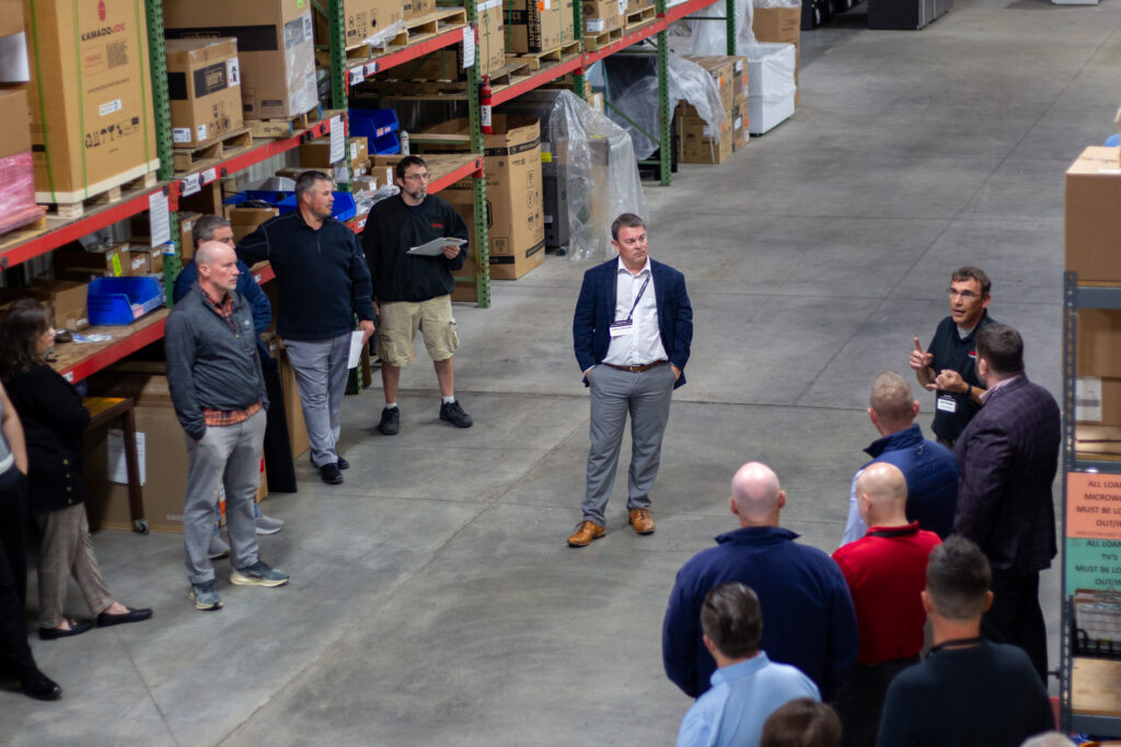 Group of people touring a warehouse
