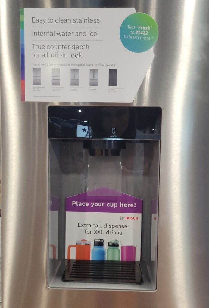 Extra tall water dispenser on a refrigerator displayed at an expo